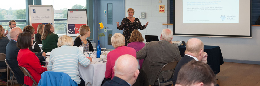 Photograph of a woman giving a presentation