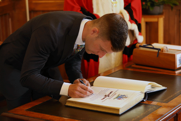 Dr Jonathan Rea MBE signing the Freedom of the Borough book at Larne Town Hall