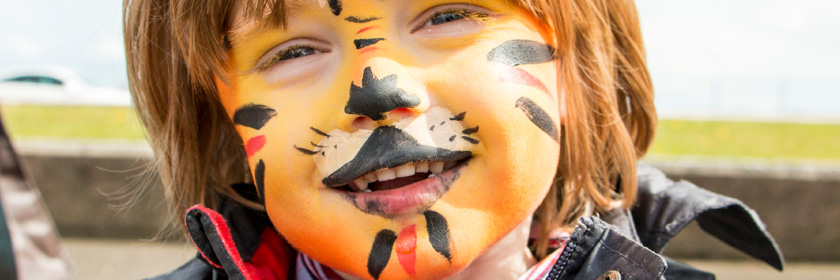 Photograph of a child with its face painted