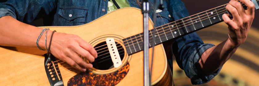 Photograph of someone playing a guitar