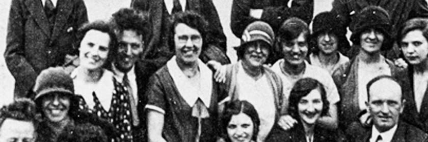 old black and white photo of a group of smiling people