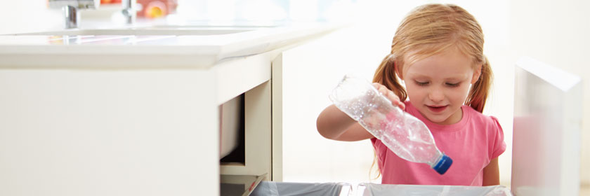 Girl recycling a bottle