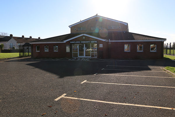 A view of the ground level, accessible entrance to Sunnylands Community Centre along with ample car parking.