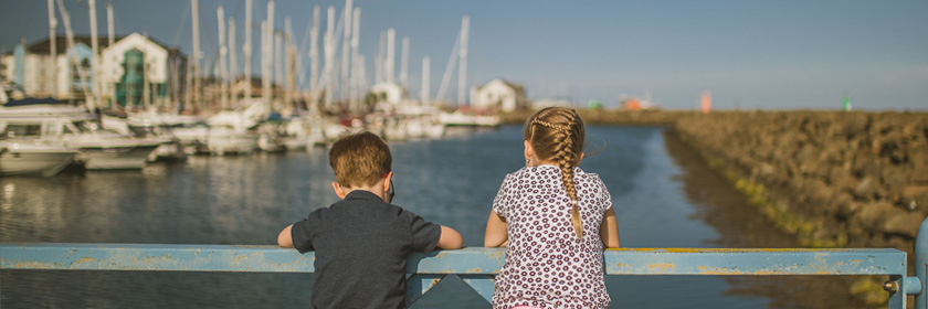 two children looking at boats in Carrickfergus Marina