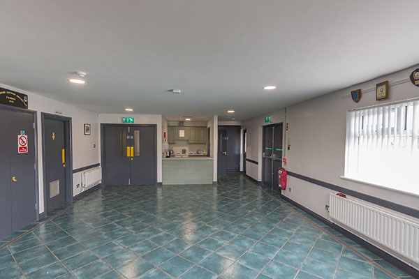 A view of the main room at Portglenone Community Centre, looking towards the entrance and kitchen area.