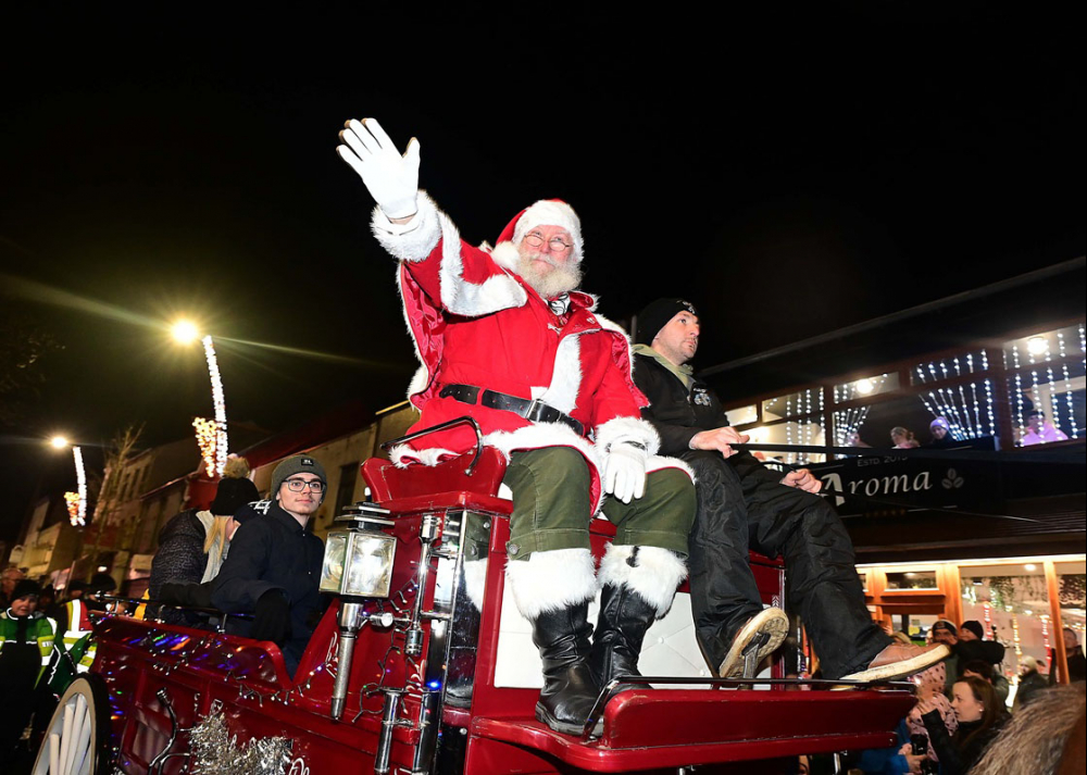 Santa waving on his Santa Sleigh for the Christmas Parade