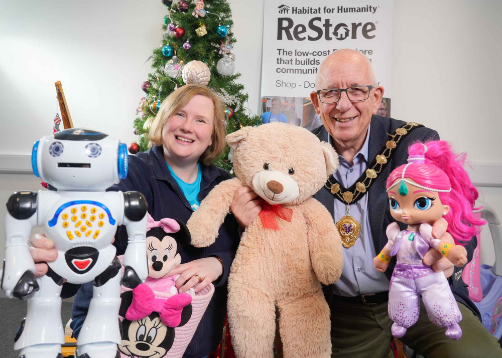 Mayor of Mid and East Antrim, Councillor Jackson Minford pictured with Isobel Kerr, ReStore Manager for Habitat for Humanity surrounded by pre-loved toys