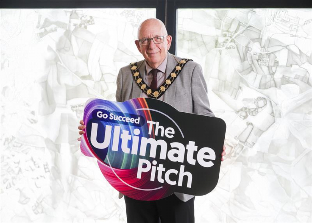 Mayor of Mid and East Antrim, Councillor Jackson Minford, holds a sign saying The Ultimate Pitch.