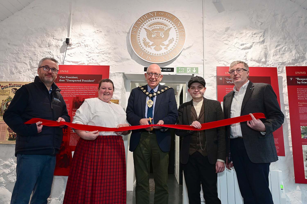 Mayor of Mid and East Antrim, Councillor Jackson Minford, (centre) cuts the ribbon at the President Arthur Homestead Interpretative Centre reopening with representatives from the Ulster Scots Agency and Arthur Cottage guides