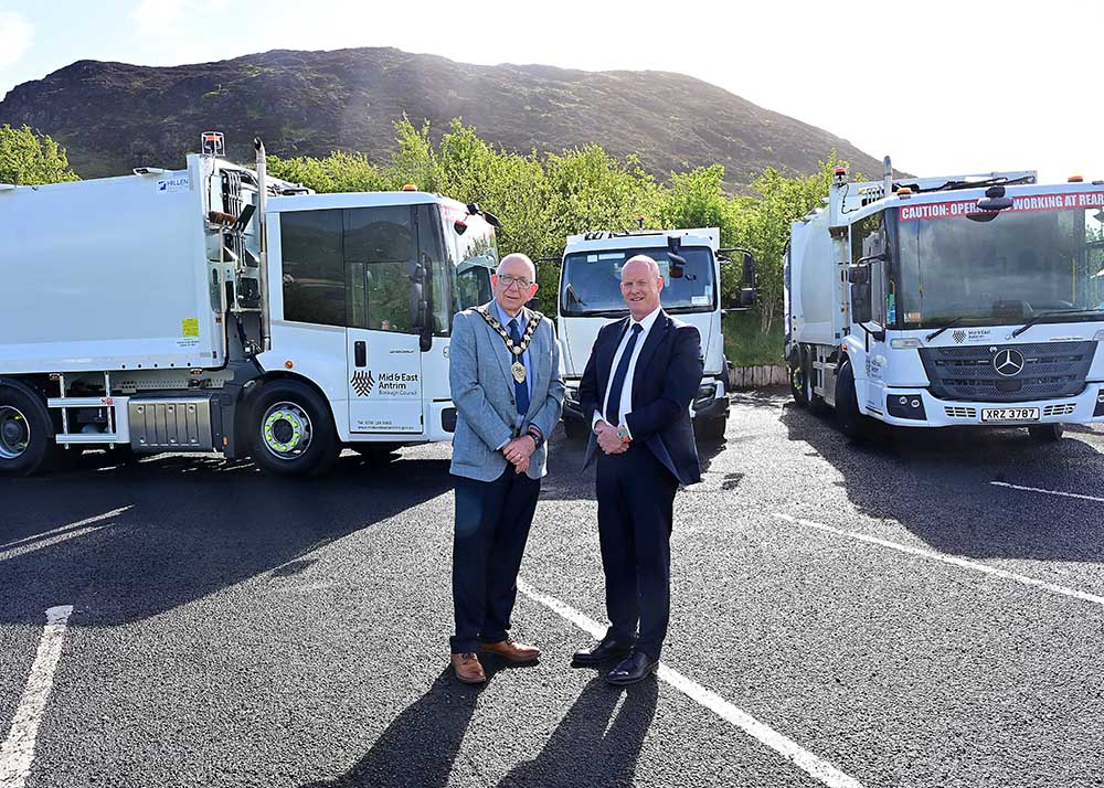 Mayor of Mid and East Antrim, Councillor Jackson Minford, and Rowan Moore, Director of Place at Mid and East Antrim Borough Council, are pictured at Slemish alongside a few of the new vehicles joining the Council’s refuse collection fleet.