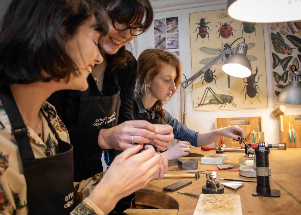 Women enjoying crafts at jewellery making workshop