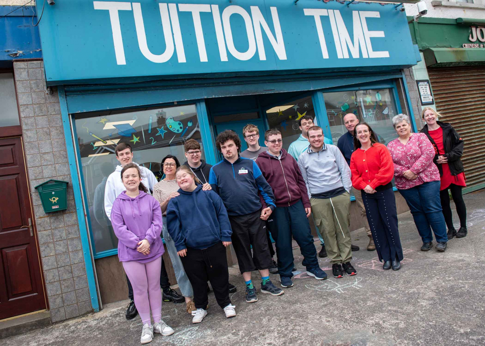 Smiles all round as Ready2Work Academy students stand outside Tuition Time with teachers and facilitators, celebrating the success of their showcase café event.